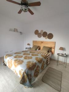 a bedroom with a bed and a ceiling fan at Casa Gara in Yaiza