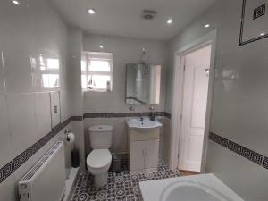 a bathroom with a toilet and a sink at Fox hill view in Parkstone