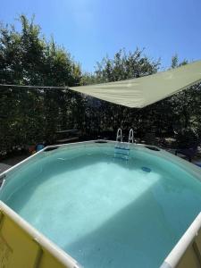 比哈奇的住宿－Villa Hacienda - Holiday Home，庭院内带遮阳伞的大型热水浴池