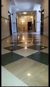 a large room with a checkered floor in a building at Hôtel privilège Oran in Oran