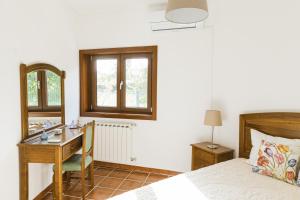 a bedroom with a desk and a bed and a mirror at Quinta do Retiro in Felgar +40 photos
