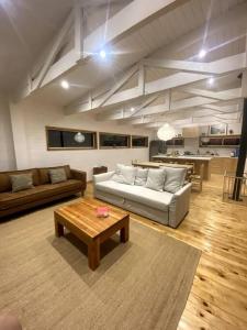 a living room with a couch and a coffee table at Buchuvillas Surf House in Buchupureo