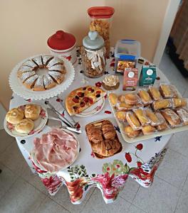 a table filled with different types of bread and pastries at B&B La Perla in Castro di Lecce