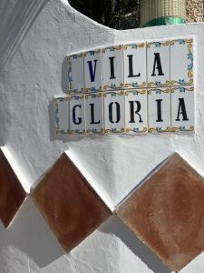 a sign that says villa lotto on a wall at Vila Glória Guesthouse in Lagos