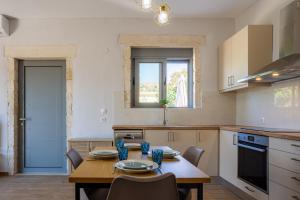 a kitchen with a table and chairs in a room at Aerino in Chania