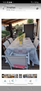 a picture of a table with a white table cloth at Mobil home in Fréjus