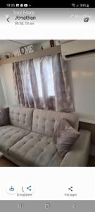 a picture of a couch in front of a window at Mobil home in Fréjus