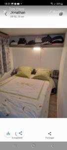 a bed with two pillows on it in a room at Mobil home in Fréjus