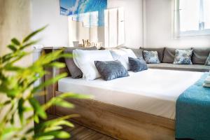 a bedroom with a large bed and a couch at Holiday House Heraklion & Roof Garden in Heraklio Town +20 photos