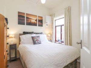 a bedroom with a large white bed and a window at Keepers Lodge - Uk38042 in Beetham