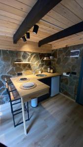 a kitchen with a wooden table with two sinks at Ayder Çalıkuşu Bungalov in Ayder Yaylasi