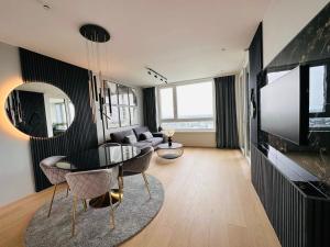a living room with a table and a couch at high-end apartment close to metro and uno-city with e-parking in Vienna