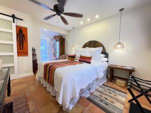 a bedroom with a bed and a ceiling fan at Casa Culinaria - The Gourmet Inn in Santa Fe