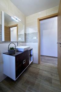 a bathroom with a sink and a mirror at O Lar de Lola in Mondariz