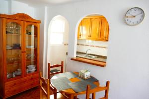 a kitchen with a table and a clock on a wall at NABILA9 in Torrevieja