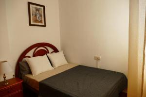 a small bedroom with a bed in a room at NABILA9 in Torrevieja