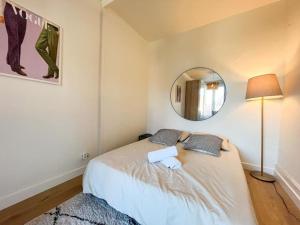 um quarto com uma cama com um espelho na parede em Suite Nairobi em Villeurbanne