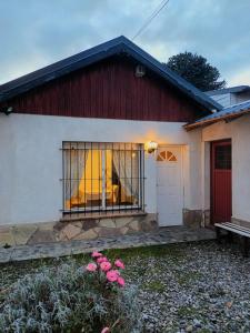 a red and white house with a window at Casa Centro Bariloche in San Carlos de Bariloche