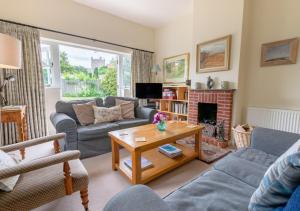 a living room with a couch and a table at Old Rectory Cottage in Orford