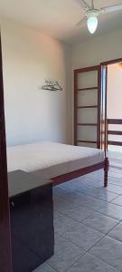 una cama sentada en una habitación junto a una pared en Ótima casa beira mar Itapoá - SC, en Itapoa
