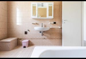 a bathroom with a sink and a tub and a toilet at House of Lake Garda in Castelnuovo del Garda +26 photos
