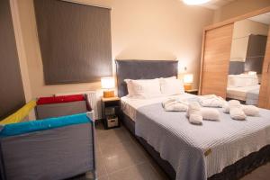 a bedroom with a bed with towels on it at Luxury Apartment in Chalkida #1 in Chalkida
