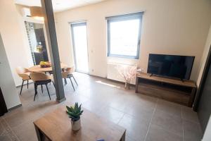 a living room with a flat screen tv and a table at Luxury Apartment in Chalkida #1 in Chalkida
