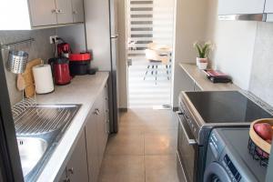 a kitchen with a sink and a counter top at Luxury Apartment in Chalkida #1 in Chalkida