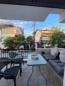 a patio with a table and chairs on a balcony at Pinelopi family Apartment in Hanioti