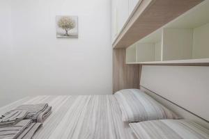 a room with a bed and a tree on the wall at Saint Simplicio House in Olbia