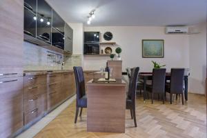 a kitchen and dining room with a table and chairs at Apartment Sahala in Tivat +38 photos