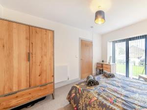 a bedroom with a large bed and a large window at Number 29 in Alnwick
