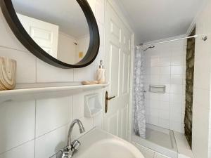 a bathroom with a sink and a mirror at Anamar Symi Residences in Symi