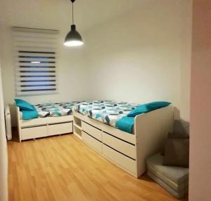 a bedroom with a bed with blue pillows on it at Cal Teixidó in Ribera de Cardós