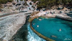 a group of people swimming in a body of water at Dhimitrulla Guest-House in Përmet