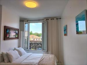 a bedroom with a bed and a large window at Paris tourist Apartment, France in Stains