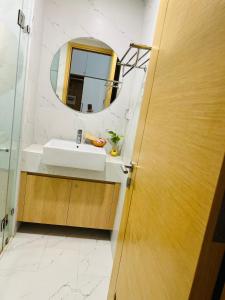 a bathroom with a sink and a mirror at TMS Luxury Hotel in Quy Nhon