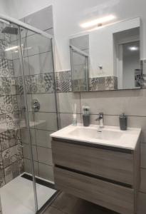 a bathroom with a sink and a shower at La casetta di salvuccio in Palermo