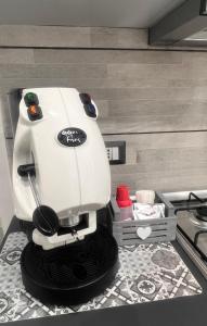 a white mixer sitting on a counter in a kitchen at La casetta di salvuccio in Palermo