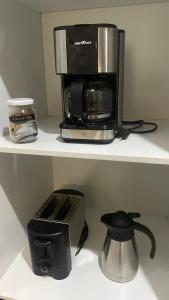 um micro-ondas e comodidades para preparar café numa prateleira em Apartamento no coração do Rio no Rio de Janeiro
