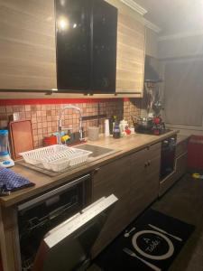 a kitchen with a sink and a counter top at Casa da Maia in Ville-la-Grand