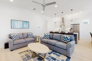 a living room with two couches and a table at Villa Lago 1969 Baytowne Loop in Destin