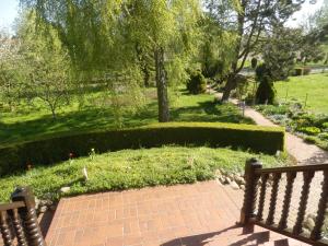 a park with a bench and a garden with trees at Bramkamp Pension in Dallgow
