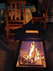 a fireplace with a fire in it in a room at La cabaña de Tito. in Ciudad Lujan de Cuyo