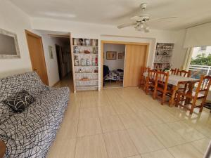 a living room and dining room with a couch and a table at Apartamento JMAP in Salou