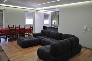 a living room with a black couch and a table at City apartment 101 in Shkodër