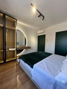 a bedroom with a large white bed in a room at City apartment 101 in Shkodër
