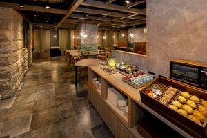 a lobby of a restaurant with a buffet of food at Kumamoto Tokyu REI Hotel in Kumamoto