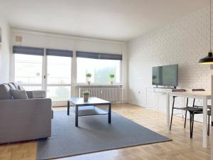 a living room with a couch and a tv at One Bedroom Apartment In Valby, Langagervej 66, in Copenhagen