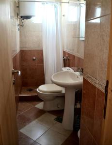 a bathroom with a toilet and a sink and a shower at Holiday house Ogi in Bar